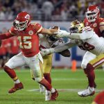Kansas City Chiefs' quarterback Patrick Mahomes, left, tries to scramble away from San Francisco 49ers' Dee Ford, center, and DeForest Buckner, right, during the second half of the NFL Super Bowl 54 football game Sunday, Feb. 2, 2020, in Miami Gardens, Fla. (AP Photo/Mark J. Terrill)