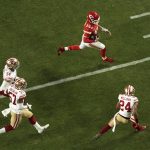 Kansas City Chiefs quarterback Patrick Mahomes (15) is pursued by San Francisco 49ers' K'Waun Williams (24), Dre Greenlaw (57), and Fred Warn (54), during the second half of the NFL Super Bowl 54 football game Sunday, Feb. 2, 2020, in Miami Gardens, Fla. (AP Photo/Morry Gash)
