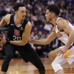 Los Angeles Clippers guard Landry Shamet (20) looks to pass as Phoenix Suns guard Devin Booker defends during the first half of an NBA basketball game, Wednesday, Feb. 26, 2020, in Phoenix. (AP Photo/Matt York)
