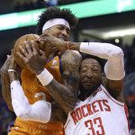 Phoenix Suns forward Kelly Oubre Jr., left, pulls a rebound away from Houston Rockets forward Robert Covington (33) as Suns guard Ricky Rubio, right, looks on during the first half of an NBA basketball game Friday, Feb. 7, 2020, in Phoenix. (AP Photo/Ross D. Franklin)