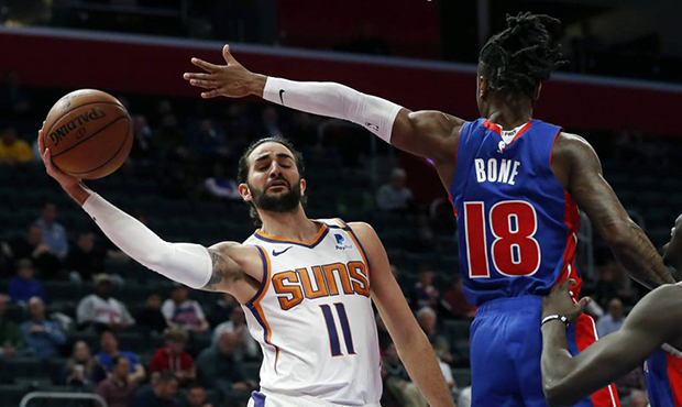 Phoenix Suns guard Ricky Rubio (11) passes as Detroit Pistons guard Jordan Bone (18) defends during...