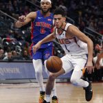 Phoenix Suns guard Devin Booker (1) chases the loose ball next to Detroit Pistons guard Bruce Brown (6) during the first half of an NBA basketball game, Wednesday, Feb. 5, 2020, in Detroit. (AP Photo/Carlos Osorio)