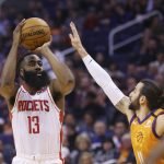 Houston Rockets guard James Harden (13) shoots a three-point basket over Phoenix Suns guard Ricky Rubio, right, during the first half of an NBA basketball game Friday, Feb. 7, 2020, in Phoenix. (AP Photo/Ross D. Franklin)