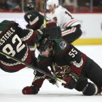 Arizona Coyotes defenseman Jason Demers (55) and defenseman Jordan Oesterle (82) collide during the first period of the team's NHL hockey game against the Chicago Blackhawks on Saturday, Feb. 1, 2020, in Glendale, Ariz. The Blackhawks won 3-2 in a shootout. (AP Photo/Ross D. Franklin)