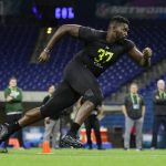 Connecticut offensive lineman Matt Peart runs a drill at the NFL football scouting combine in Indianapolis, Friday, Feb. 28, 2020. (AP Photo/Michael Conroy)