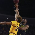 Oregon's Francis Okoro (33) puts up a shot over Arizona State's Jalen Graham (24) during the first half of an NCAA college basketball game Thursday, Feb. 20, 2020, in Tempe, Ariz. (AP Photo/Darryl Webb)