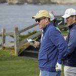 Peyton Manning, left, and his brother, Eli Manning, look over the seventh green of the Pebble Beach Golf Links before hitting from the tee during the third round of the AT&T Pebble Beach National Pro-Am golf tournament Saturday, Feb. 8, 2020, in Pebble Beach, Calif. (AP Photo/Eric Risberg)