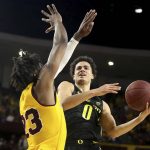 Oregon's Will Richardson (0) drive to the basket against Arizona State's Romello White (23) during the first half of an NCAA college basketball game Thursday, Feb. 20, 2020, in Tempe, Ariz. (AP Photo/Darryl Webb)