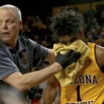 Arizona State's trainer attends to Remy Martin after getting elbowed twice against Oregon during the first half of an NCAA college basketball game Thursday, Feb. 20, 2020, in Tempe, Ariz. (AP Photo/Darryl Webb)