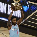 Miami Heat's Derrick Jones Jr. holds the trophy after winning the NBA All-Star slam dunk contest Saturday, Feb. 15, 2020, in Chicago. (AP Photo/David Banks)