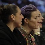 U.S. Women's soccor players Diana Taurasi, Megan Papinoe and Sue Bird are seen during the second half of the NBA All-Star basketball game Sunday, Feb. 16, 2020, in Chicago. (AP Photo/Nam Huh)