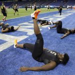 Louisville offensive lineman Mekhi Becton stretches at the NFL football scouting combine in Indianapolis, Friday, Feb. 28, 2020. (AP Photo/Charlie Neibergall)