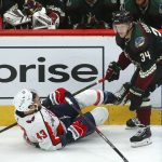 Arizona Coyotes center Carl Soderberg (34) sends Washington Capitals right wing Tom Wilson (43) to the ice during the first period of an NHL hockey game Saturday, Feb. 15, 2020, in Glendale, Ariz. (AP Photo/Ross D. Franklin)