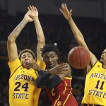 Southern California guard Jonah Mathews, center, passes the ball to a teammate as Arizona State forward Jalen Graham (24) and guard Alonzo Verge Jr. (11) defend during the first half of an NCAA college basketball game Saturday, Feb. 8, 2020, in Tempe, Ariz. (AP Photo/Ross D. Franklin)