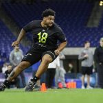 Washington offensive lineman Nick Harris runs a drill at the NFL football scouting combine in Indianapolis, Friday, Feb. 28, 2020. (AP Photo/Michael Conroy)