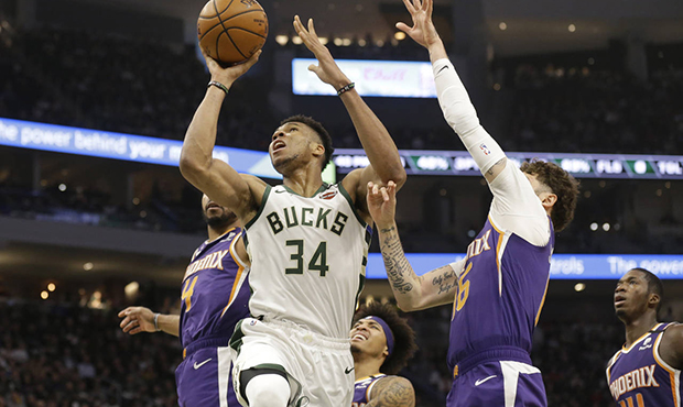 Milwaukee Bucks' Giannis Antetokounmpo (34) shoots against the Phoenix Suns during the first half o...