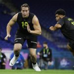 North Carolina offensive lineman Charlie Heck (19) and Washington offensive lineman Nick Harris runs a drill at the NFL football scouting combine in Indianapolis, Friday, Feb. 28, 2020. (AP Photo/Michael Conroy)
