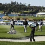 Phil Mickelson, front right, hits out of a bunker on the fourth fairway of the Pebble Beach Golf Links during the final round of the AT&T Pebble Beach National Pro-Am golf tournament Sunday, Feb. 9, 2020, in Pebble Beach, Calif. (AP Photo/Eric Risberg)
