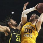 Arizona State's Mickey Mitchell (00) eyes the basket as Oregon's Addison Patterson (22) defends during the second half of an NCAA college basketball game Thursday, Feb. 20, 2020, in Tempe, Ariz. (AP Photo/Darryl Webb)