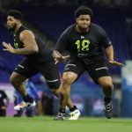 Washington offensive lineman Nick Harris (18) and Missouri offensive lineman Yasir Durant run a drill at the NFL football scouting combine in Indianapolis, Friday, Feb. 28, 2020. (AP Photo/Michael Conroy)