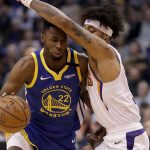 Golden State Warriors guard Andrew Wiggins (22) dries against Phoenix Suns forward Kelly Oubre Jr. during the first half of an NBA basketball game, Wednesday, Feb. 12, 2020, in Phoenix. (AP Photo/Matt York)