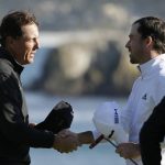 Nick Taylor, right, of Canada, is greeted by Phil Mickelson on the 18th green of the Pebble Beach Golf Links after winning the AT&T Pebble Beach National Pro-Am golf tournament Sunday, Feb. 9, 2020, in Pebble Beach, Calif. (AP Photo/Eric Risberg)
