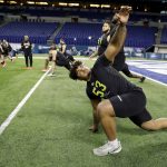 Iowa offensive lineman Tristan Wirfs stretches at the NFL football scouting combine in Indianapolis, Friday, Feb. 28, 2020. (AP Photo/Charlie Neibergall)