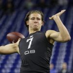 Oregon quarterback Justin Herbert runs a drill at the NFL football scouting combine in Indianapolis, Thursday, Feb. 27, 2020. (AP Photo/Michael Conroy)