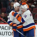 New York Islanders left wing Anthony Beauvillier (18) celebrates with Andy Greene after scoring a goal against the Arizona Coyotes in the third period during an NHL hockey game, Monday, Feb. 17, 2020, in Glendale, Ariz. Coyotes won 2-1. (AP Photo/Rick Scuteri)