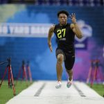 Wisconsin running back Jonathan Taylor runs the 40-yard dash at the NFL football scouting combine in Indianapolis, Friday, Feb. 28, 2020. (AP Photo/Michael Conroy)
