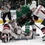 Arizona Coyotes goaltender Adin Hill (31) defends a shot in front of Dallas Stars right wing Corey Perry (10) and Coyotes defenseman Niklas Hjalmarsson (4) during the first period of an NHL hockey game in Dallas, Wednesday, Feb. 19, 2019. (AP Photo/Michael Ainsworth)