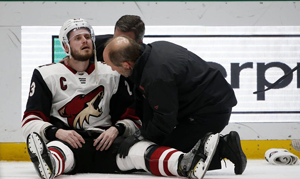 Arizona Coyotes defenseman Oliver Ekman-Larsson (23) is examined by trainers after a hit by Dallas ...