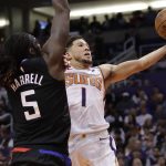 Phoenix Suns guard Devin Booker (1) shoots over Los Angeles Clippers forward Montrezl Harrell (5) during the second half of an NBA basketball game, Wednesday, Feb. 26, 2020, in Phoenix. (AP Photo/Matt York)