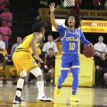 UCLA's Tyger Campbell (10) calls out a play at midcourt while being covered by Arizona State's Remy Martin (1) during the first half of an NCAA college basketball game Thursday, Feb. 6, 2020, in Tempe, Ariz. (AP Photo/Darryl Webb)