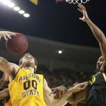 Arizona State's Mickey Mitchell (00) hauls in a rebound next to Oregon's Shakur Justin (10) during the second half of an NCAA college basketball game Thursday, Feb. 20, 2020, in Tempe, Ariz. (AP Photo/Darryl Webb)