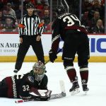 Arizona Coyotes goaltender Antti Raanta (32) makes a kick-save against the Chicago Blackhawks as Coyotes center Carl Soderberg (34) and referee Jean Hebert, top center, looks on during the third period of an NHL hockey game Saturday, Feb. 1, 2020, in Glendale, Ariz. (AP Photo/Ross D. Franklin)