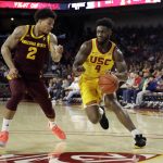 
              Southern California guard Daniel Utomi (4) dribbles next to Arizona State guard Rob Edwards (2) during the first half of an NCAA college basketball game Saturday, Feb. 29, 2020, in Los Angeles. (AP Photo/Marcio Jose Sanchez)
            