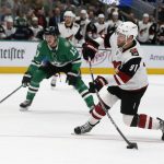 Arizona Coyotes left wing Taylor Hall (91) shoots for a goal in front of Dallas Stars center Mattias Janmark (13) during the second period of an NHL hockey game in Dallas, Wednesday, Feb. 19, 2019. (AP Photo/Michael Ainsworth)