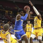 UCLA's Cody Riley (2) knocks down Arizona State's Mickey Mitchell (00) as Arizona State's Romello White (23) goes for the ball during the first half of an NCAA college basketball game Thursday, Feb. 6, 2020, in Tempe, Ariz. (AP Photo/Darryl Webb)