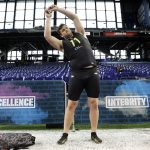 Boise State offensive lineman Ezra Cleveland stretches at the NFL football scouting combine in Indianapolis, Friday, Feb. 28, 2020. (AP Photo/Charlie Neibergall)