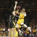 Arizona State's Remy Martin (1) looks for an open teammate as Oregon's Addison Patterson (22) defends during the second half of an NCAA college basketball game Thursday, Feb. 20, 2020, in Tempe, Ariz. (AP Photo/Darryl Webb)