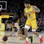 Oregon's Will Richardson (0) loses his balance after running into Arizona State's Rob Edwards (2) during the first half of an NCAA college basketball game Thursday, Feb. 20, 2020, in Tempe, Ariz. (AP Photo/Darryl Webb)