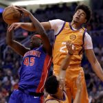 Detroit Pistons forward Sekou Doumbouya (45) pulls down a rebound over Phoenix Suns forward Cameron Johnson (23) during the first half of an NBA game, Friday, Feb. 28, 2020, in Phoenix. (AP Photo/Matt York)