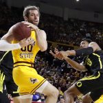 Arizona State's Mickey Mitchell (00) wins a loose ball against Oregon's Chandler Lawson (13) during the first half of an NCAA college basketball game Thursday, Feb. 20, 2020, in Tempe, Ariz. (AP Photo/Darryl Webb)