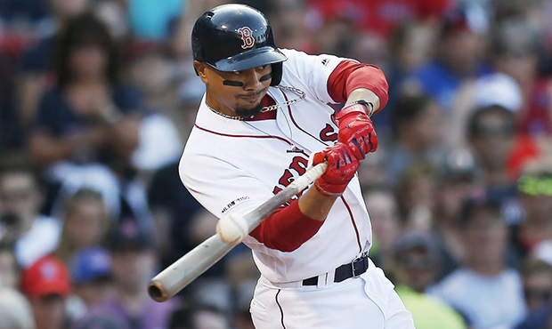 FILE - In this Aug. 10, 2019, file photo, Boston Red Sox's Mookie Betts hits an RBI-double during t...