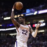 Phoenix Suns center Deandre Ayton (22) rebounds during the first half of an NBA basketball game against the Los Angeles Clippers, Wednesday, Feb. 26, 2020, in Phoenix. (AP Photo/Matt York)