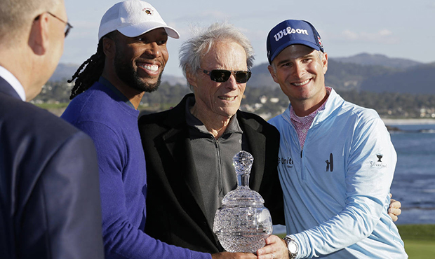 Larry Fitzgerald, left, and Kevin Streelman, right, pose with their trophy and Clint Eastwood, cent...