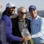 Larry Fitzgerald, left, and Kevin Streelman, right, pose with their trophy and Clint Eastwood, center, at the Pebble Beach Golf Links after winning the team title of the AT&T Pebble Beach National Pro-Am golf tournament Sunday, Feb. 9, 2020, in Pebble Beach, Calif. (AP Photo/Eric Risberg)