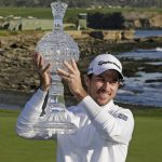 Nick Taylor, of Canada, poses with his trophy on the 18th green of the Pebble Beach Golf Links after winning the AT&T Pebble Beach National Pro-Am golf tournament Sunday, Feb. 9, 2020, in Pebble Beach, Calif. (AP Photo/Eric Risberg)