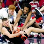 Oregon State forward Tres Tinkle (3) battles for the ball with Arizona guard Nico Mannion (1) and Zeke Nnaji during the second half of an NCAA college basketball game Thursday, Feb. 20, 2020, in Tucson, Ariz. (AP Photo/Rick Scuteri)